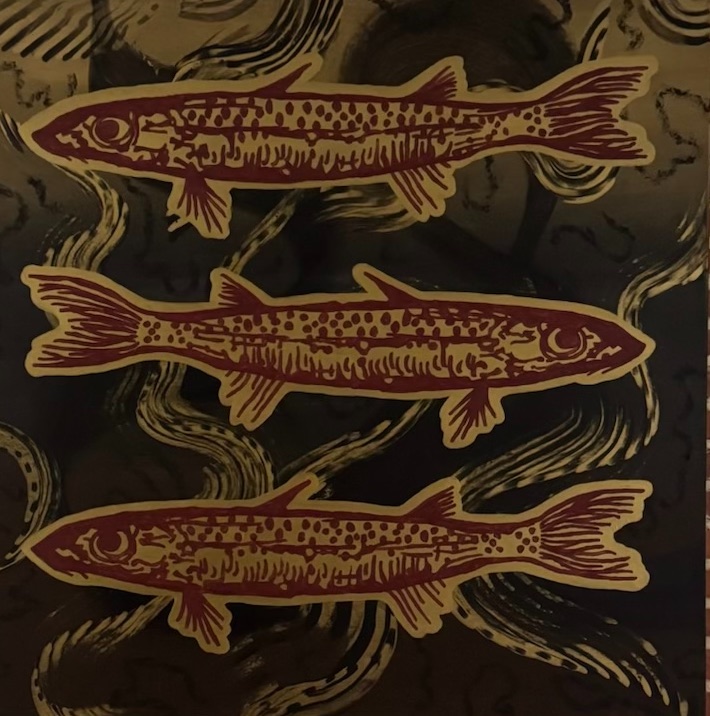 Three fish, block-print style, in red and gold